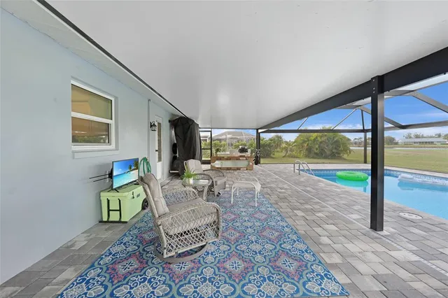 a living room with furniture and a floor to ceiling window