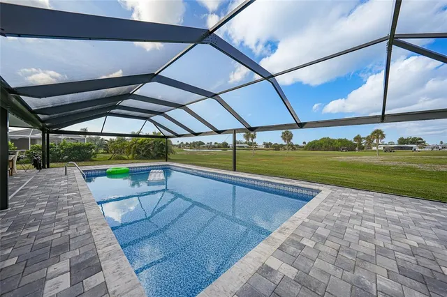 a view of swimming pool with yard and sitting area