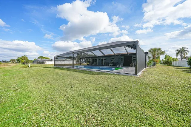 a view of a big yard with table and chairs and a yard
