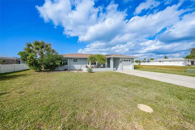 a view of an house with backyard space and a lake view in back