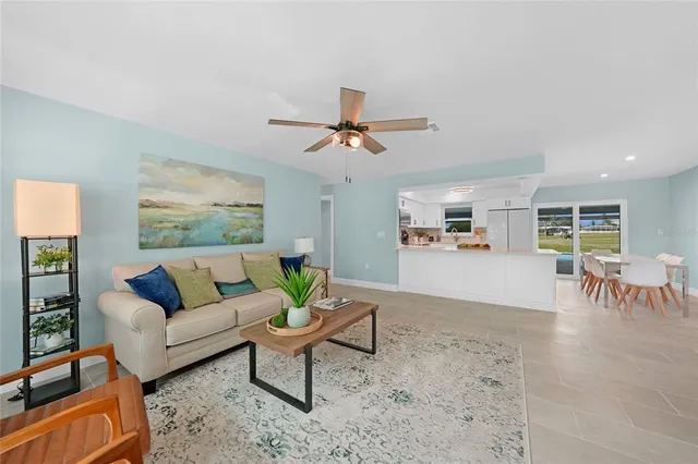 a living room with furniture and a table with potted plants