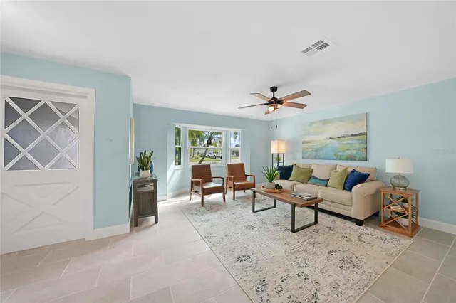 a living room with furniture and a ceiling fan