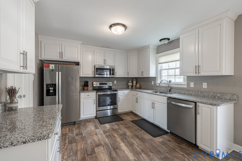 241 Pleasant View Drive Aylett, VA 23009 - Photo 12 of 36 a kitchen with granite countertop white cabinets and stainless steel appliances
