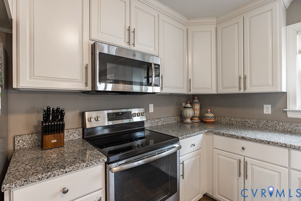 241 Pleasant View Drive Aylett, VA 23009 - Photo 15 of 36 a kitchen with granite countertop white cabinets stainless steel appliances and a sink