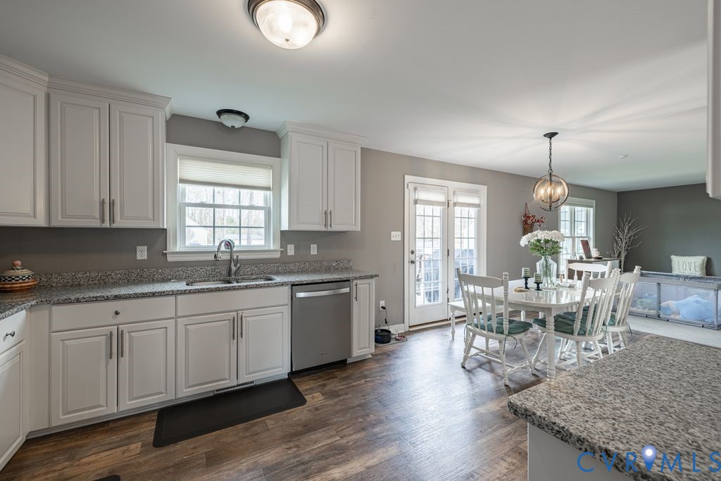 241 Pleasant View Drive Aylett, VA 23009 - Photo 17 of 36 a large kitchen with granite countertop a stove a sink a dining table and chairs