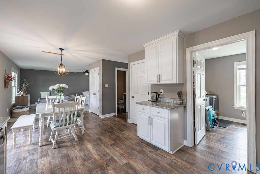 241 Pleasant View Drive Aylett, VA 23009 - Photo 18 of 36 a kitchen with stainless steel appliances a dining table chairs stove and cabinets