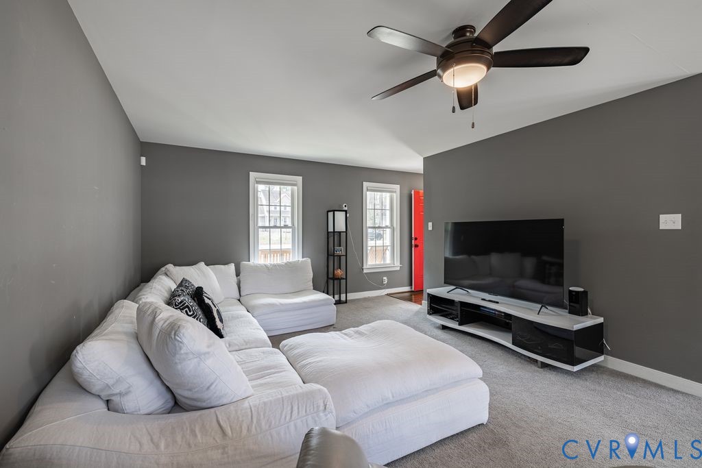 241 Pleasant View Drive Aylett, VA 23009 - Photo 22 of 36 a living room with furniture a flat screen tv and a ceiling fan