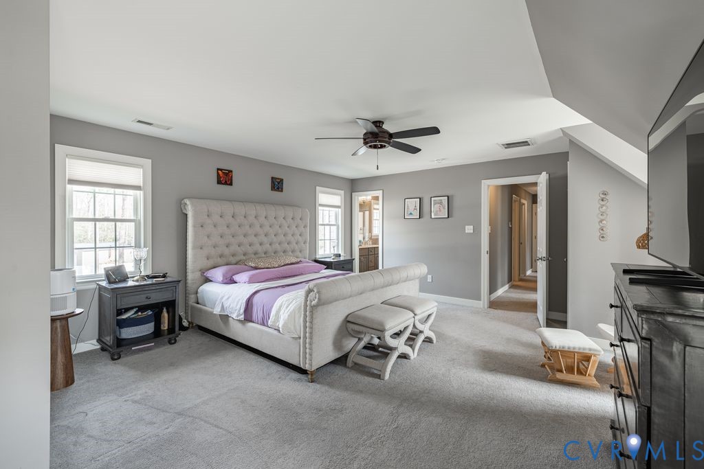 241 Pleasant View Drive Aylett, VA 23009 - Photo 29 of 36 a spacious bedroom with a bed and a chandelier