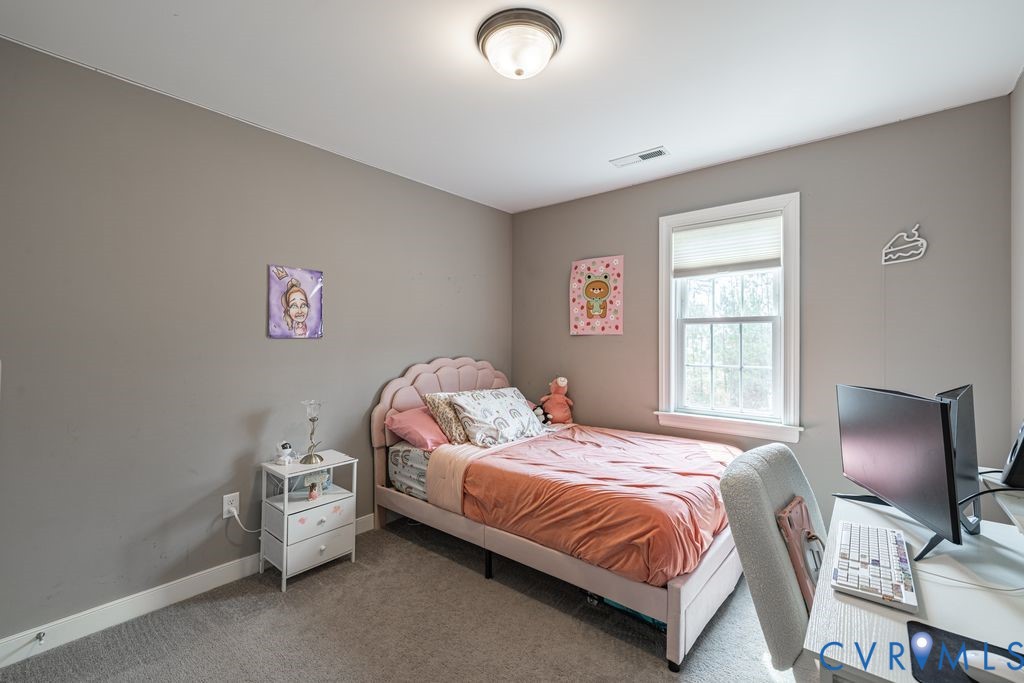 241 Pleasant View Drive Aylett, VA 23009 - Photo 33 of 36 a bedroom with a bed and a chair