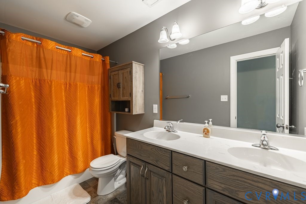 241 Pleasant View Drive Aylett, VA 23009 - Photo 34 of 36 a bathroom with a double vanity sink toilet and a mirror