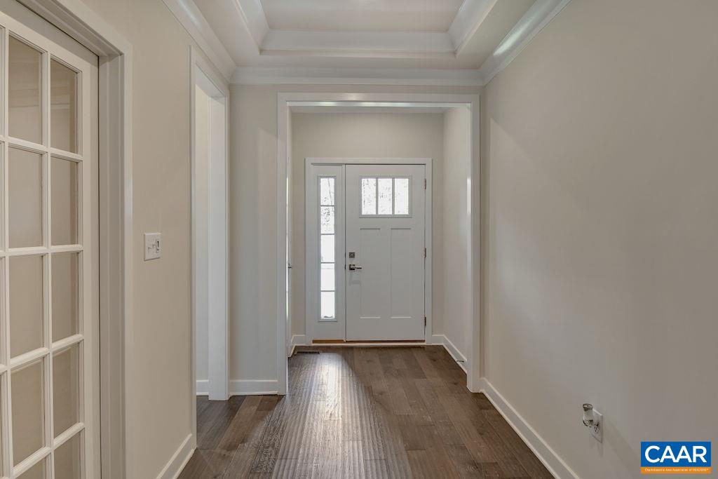 351 Winding Road Keswick, VA 22947 - Photo 15 of 21 a view of an empty room with wooden floor and a window