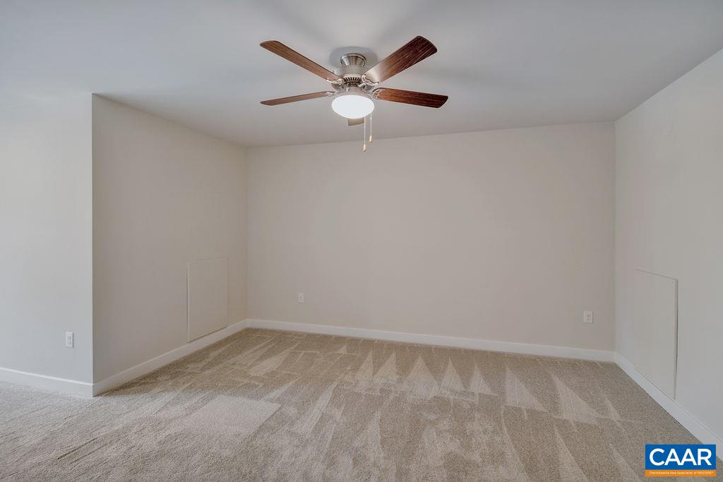 351 Winding Road Keswick, VA 22947 - Photo 16 of 21 a view of an empty room with wooden floor