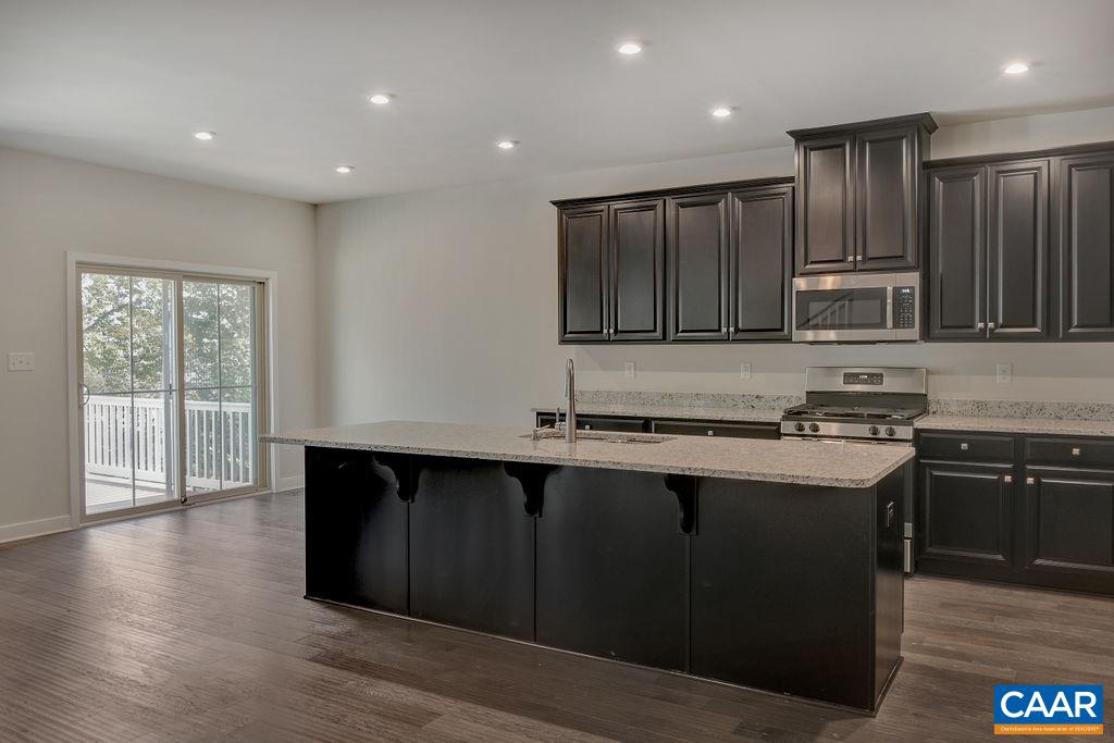 351 Winding Road Keswick, VA 22947 - Photo 3 of 21 a kitchen with wooden cabinets and a sink