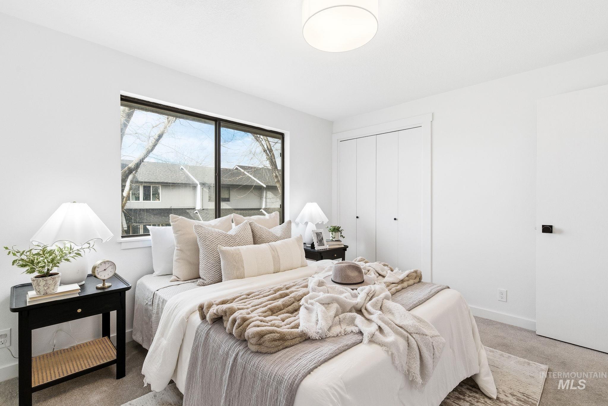8443 West Rifleman Street Boise, ID 83704 - Photo 24 of 39 Carpeted bedroom featuring baseboards and a closet