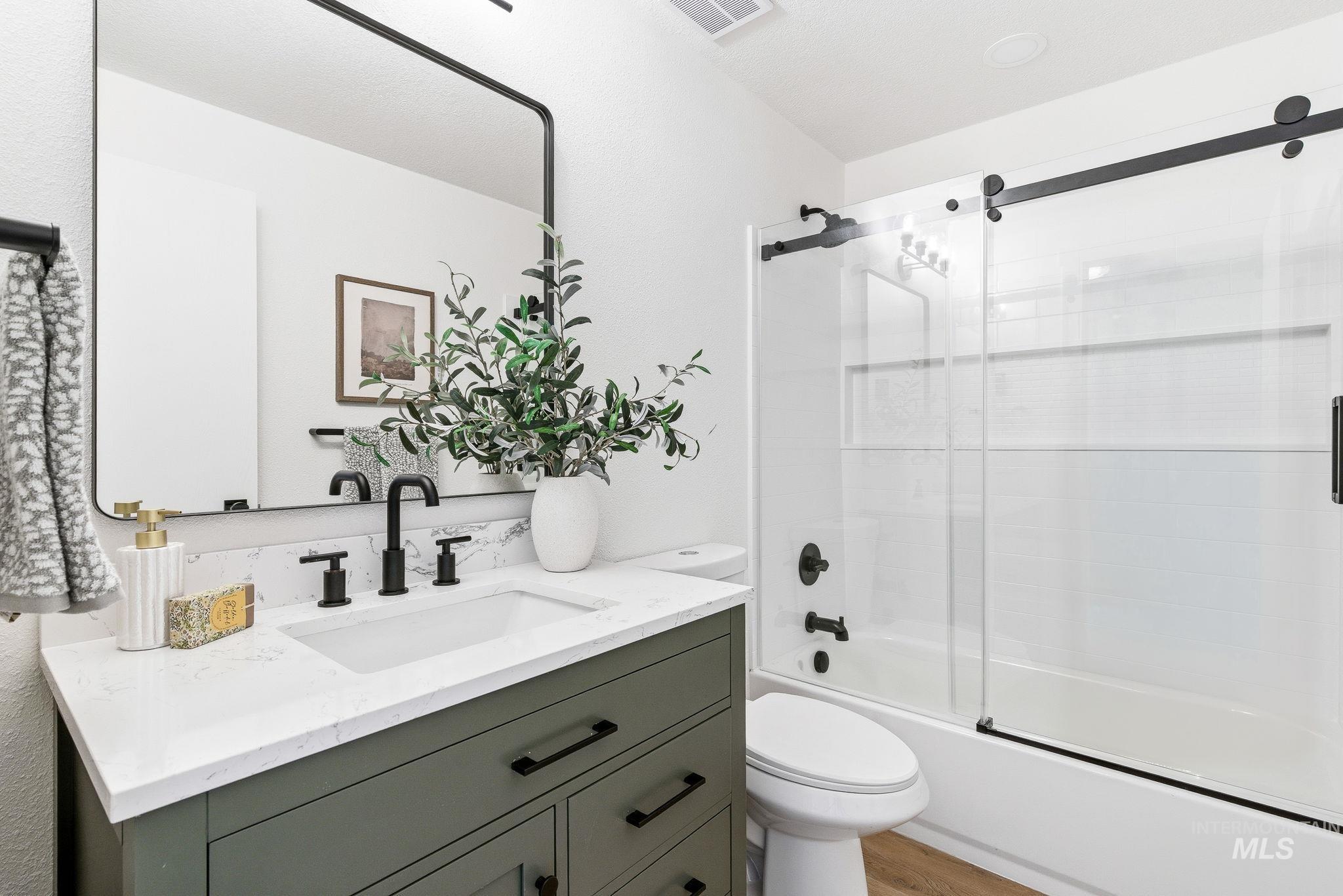 8443 West Rifleman Street Boise, ID 83704 - Photo 26 of 39 Full bath featuring bath / shower combo with glass door and vanity