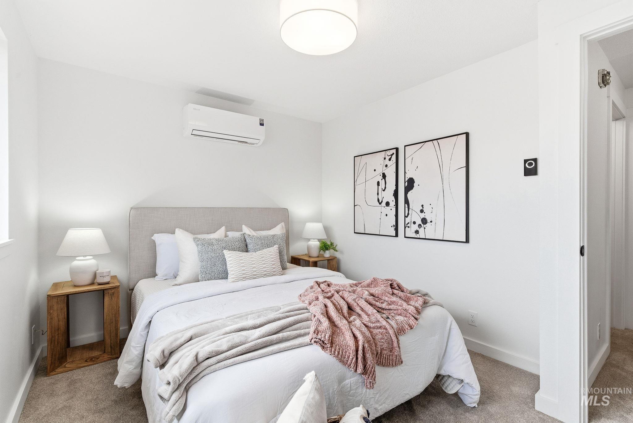 8443 West Rifleman Street Boise, ID 83704 - Photo 29 of 39 Carpeted bedroom featuring a wall mounted mini split and baseboards