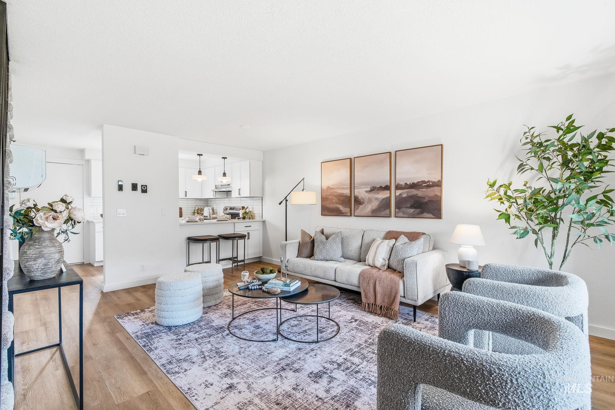 8443 West Rifleman Street Boise, ID 83704 - Photo 3 of 39 Living room featuring wood finished floors and baseboards