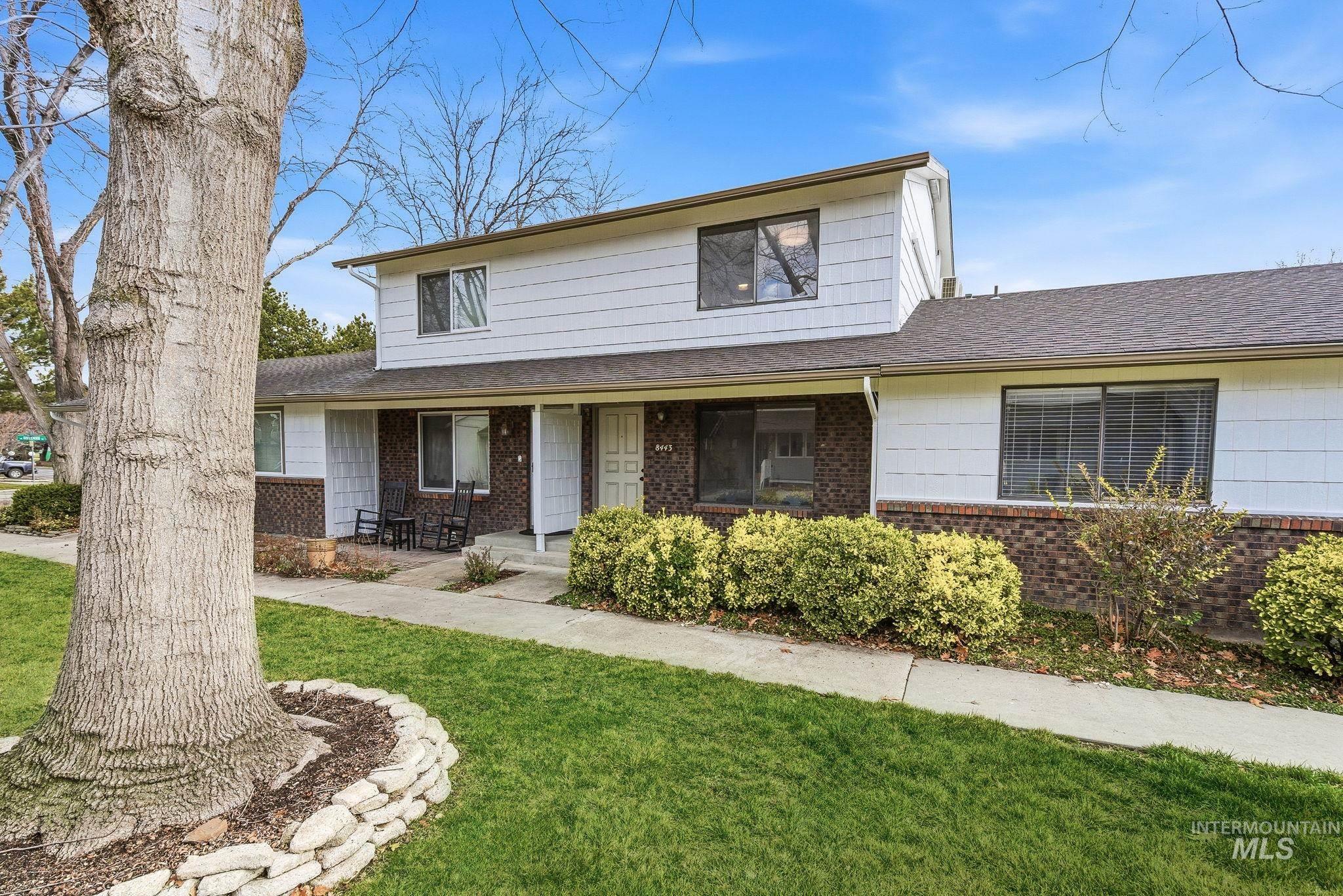 8443 West Rifleman Street Boise, ID 83704 - Photo 38 of 39 Traditional-style house with a front lawn, a shingled roof, covered porch, and brick siding
