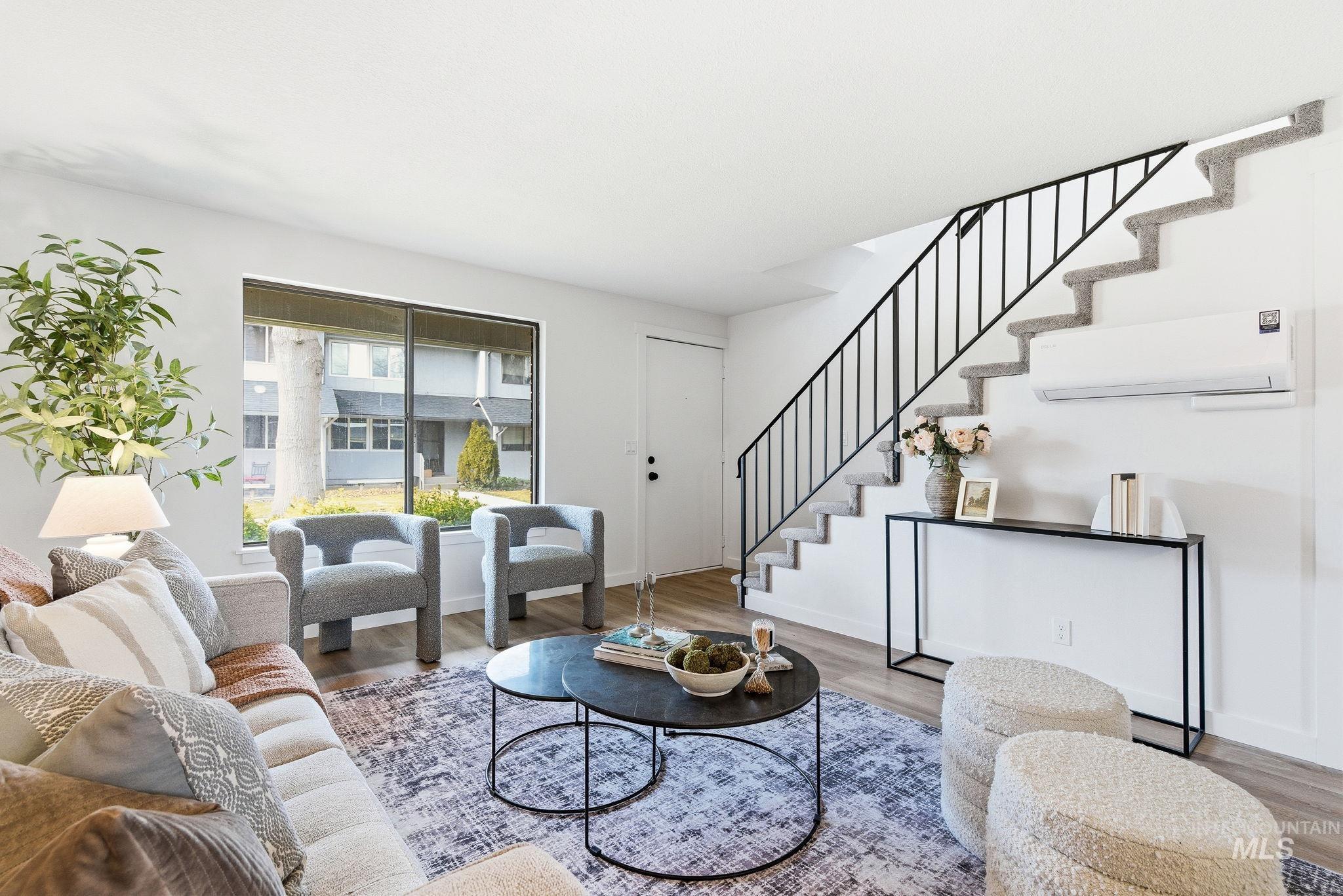 8443 West Rifleman Street Boise, ID 83704 - Photo 6 of 39 Living area with wood finished floors and a mini split for heating / cooling
