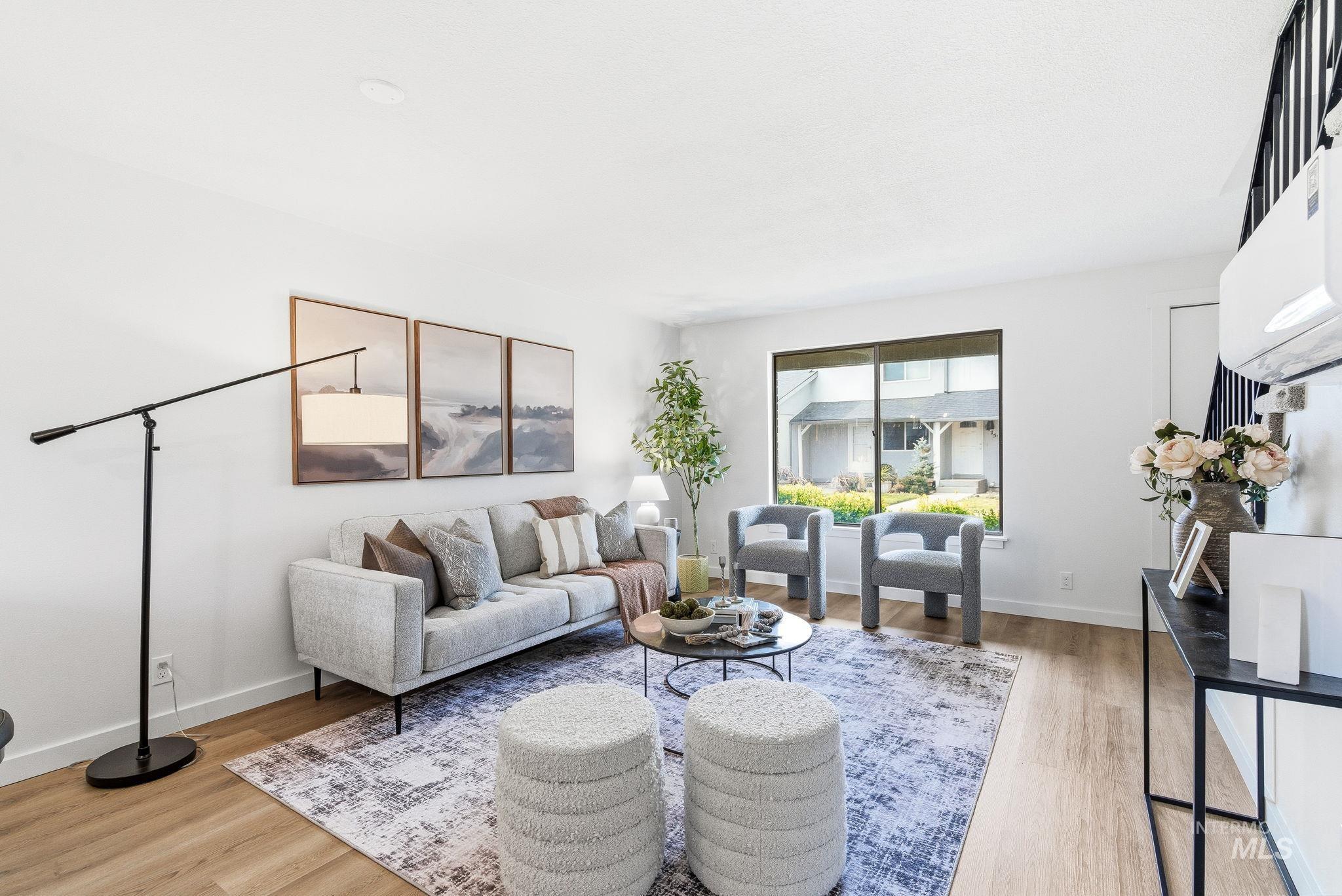 8443 West Rifleman Street Boise, ID 83704 - Photo 8 of 39 Living room featuring light wood-style floors and baseboards