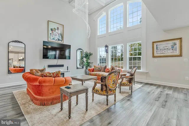 a living room with stainless steel appliances kitchen island granite countertop furniture and a wooden floors