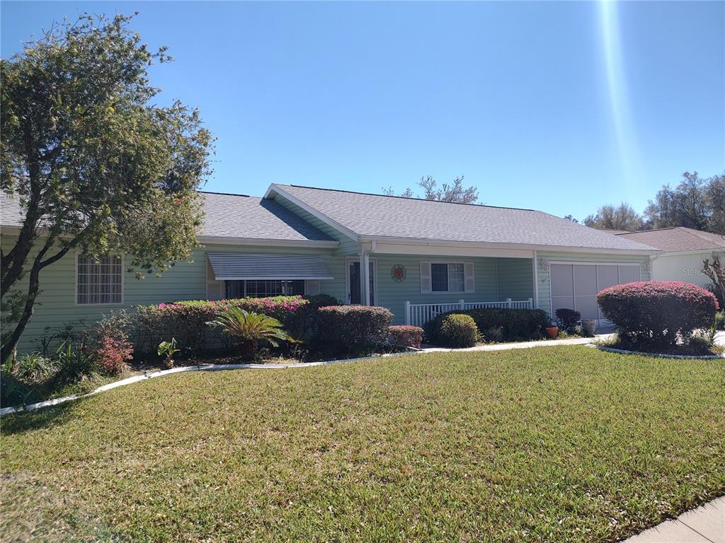 a view of a house with a yard and garage