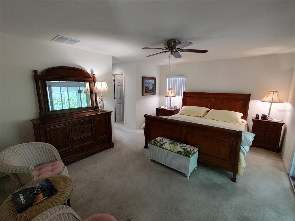 14191 Southwest 115th Terrace Dunnellon, FL 34432 - Photo 16 of 36 a bedroom with a bed dresser and a window