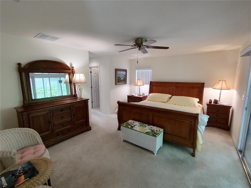 14191 Southwest 115th Terrace Dunnellon, FL 34432 - Photo 17 of 36 a bedroom with a bed a dresser and dresser