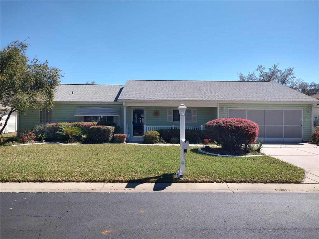 14191 Southwest 115th Terrace Dunnellon, FL 34432 - Photo 2 of 36 a front view of a house with yard and garage