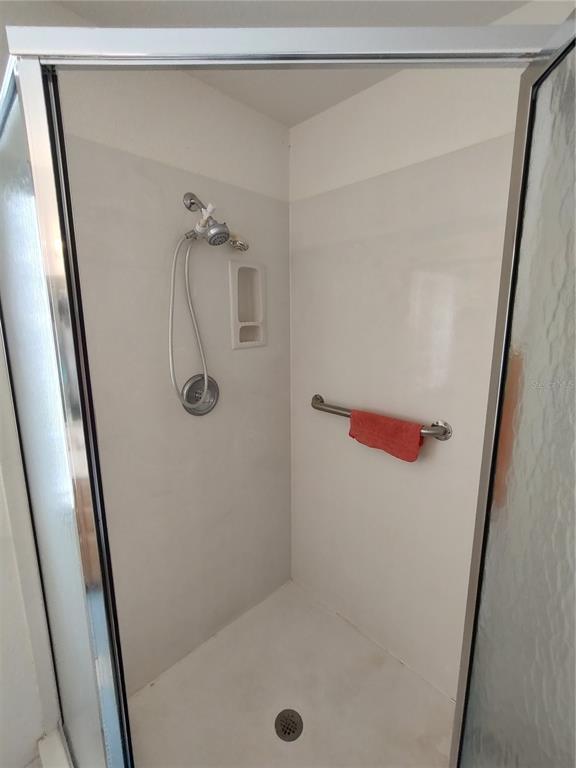 14191 Southwest 115th Terrace Dunnellon, FL 34432 - Photo 21 of 36 a bathroom with a glass shower door