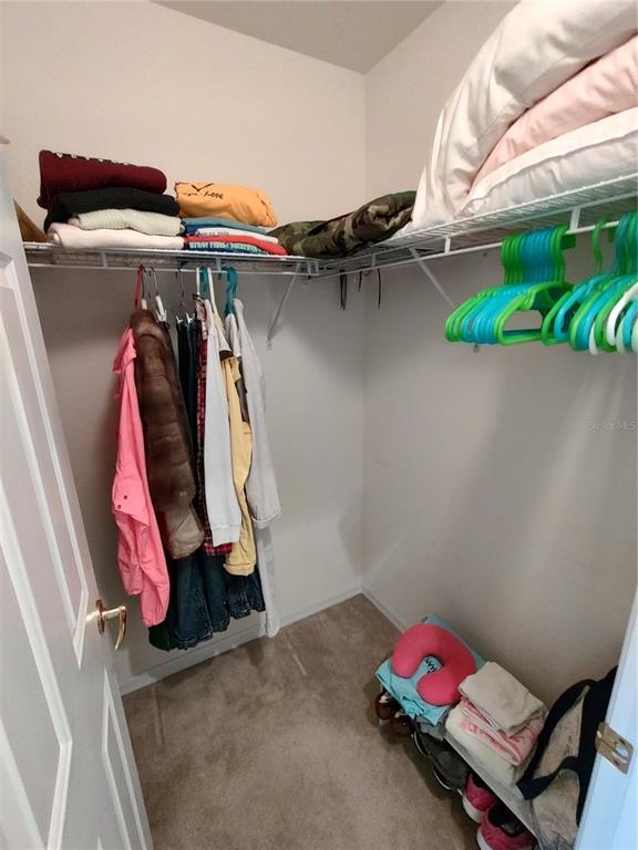 14191 Southwest 115th Terrace Dunnellon, FL 34432 - Photo 22 of 36 a view of walk in closet with clothes and shoes