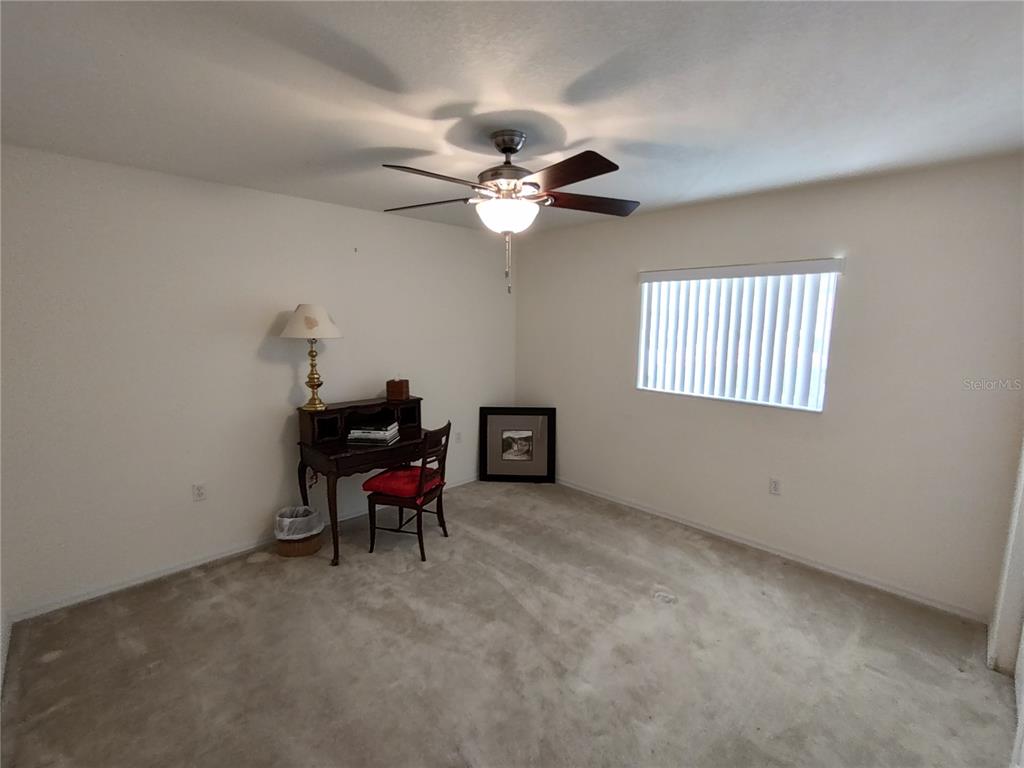 14191 Southwest 115th Terrace Dunnellon, FL 34432 - Photo 25 of 36 a living room with furniture a chandelier and a window
