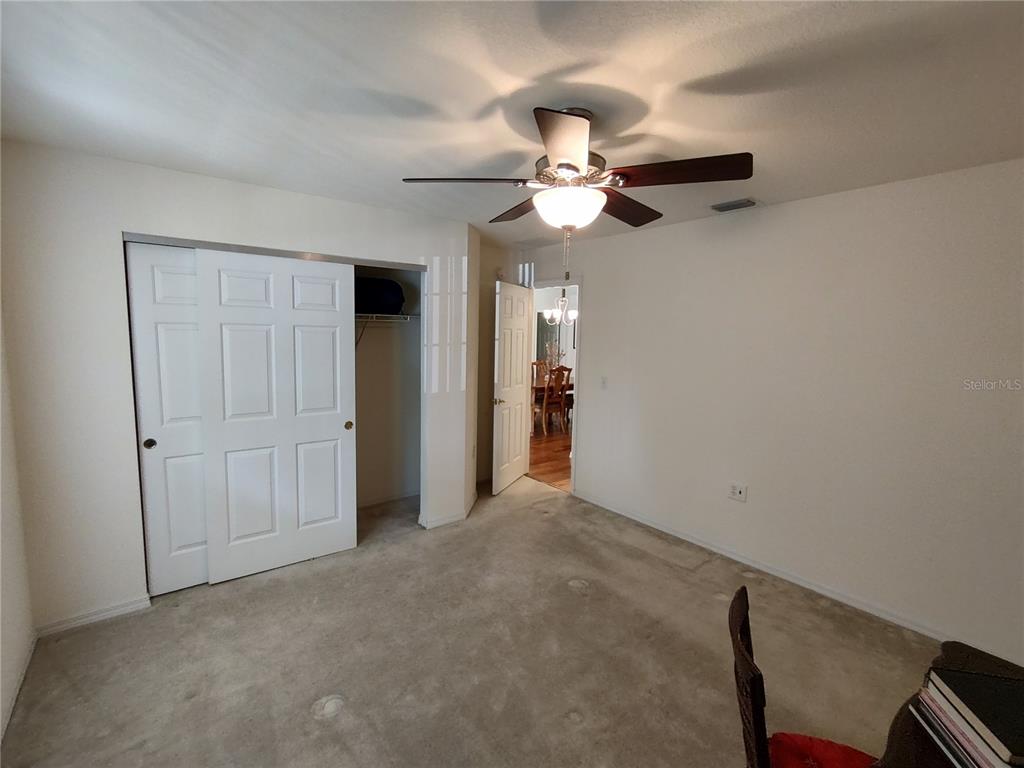 14191 Southwest 115th Terrace Dunnellon, FL 34432 - Photo 27 of 36 a view of an empty room and a chandelier fan