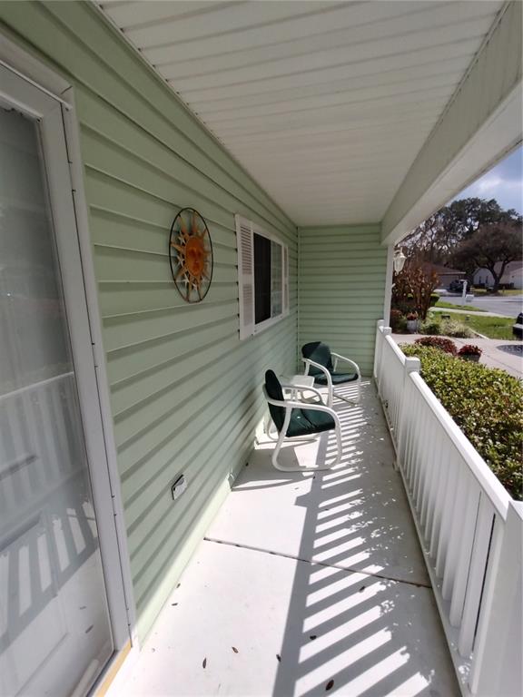 14191 Southwest 115th Terrace Dunnellon, FL 34432 - Photo 4 of 36 a view of a balcony with chairs and a rug