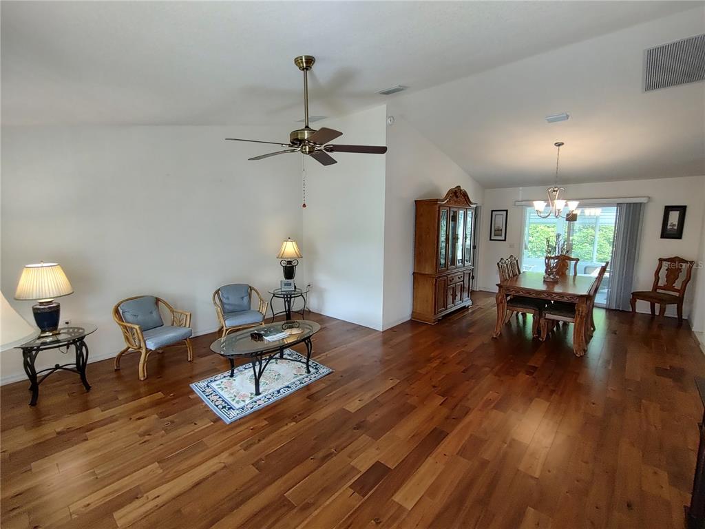 14191 Southwest 115th Terrace Dunnellon, FL 34432 - Photo 6 of 36 a living room with furniture and a wooden floor