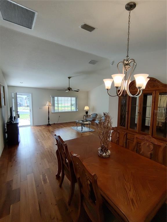 14191 Southwest 115th Terrace Dunnellon, FL 34432 - Photo 9 of 36 a view of a dining room with furniture and wooden floor