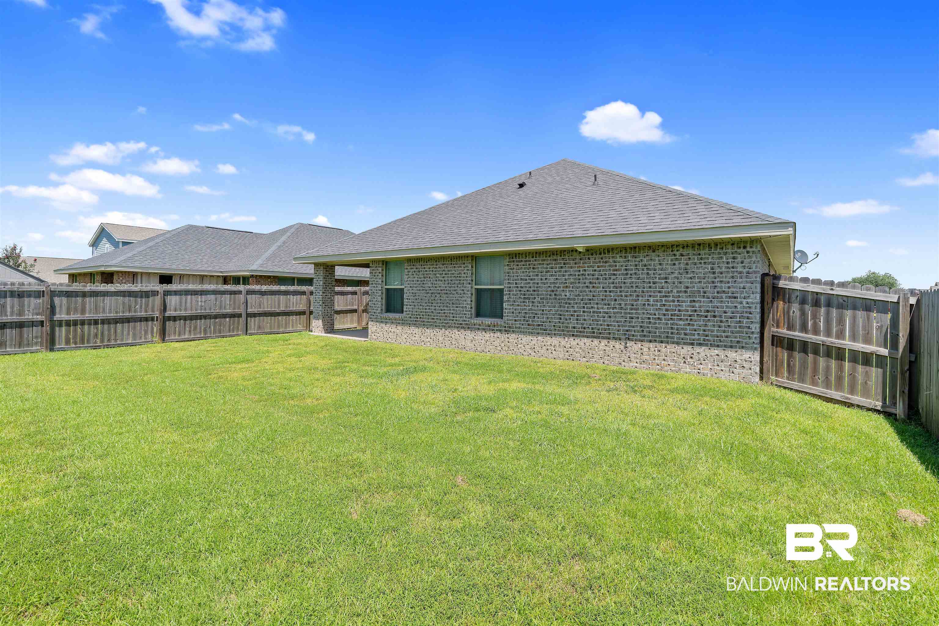 8823 Allay Lane Foley, AL 36535 - Photo 15 of 18 Rear view of property featuring a lawn