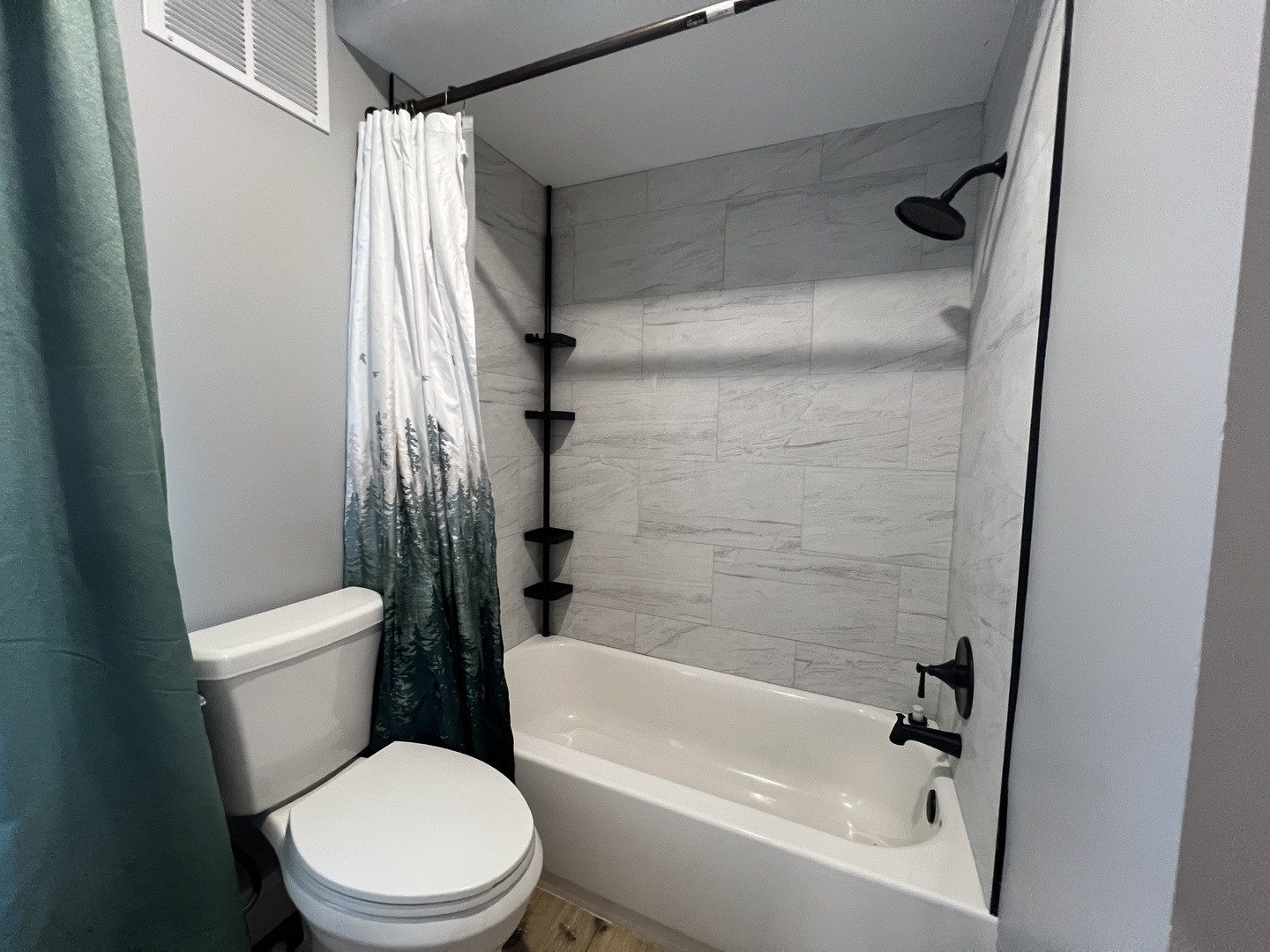 200 East South Street Ellsworth, IL 61737 - Photo 11 of 19 a white toilet sitting next to a bath tub