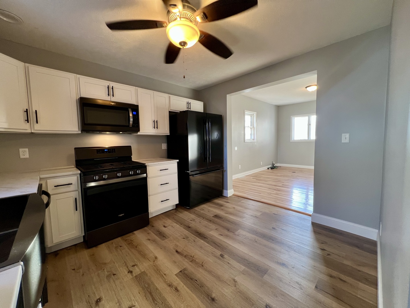 200 East South Street Ellsworth, IL 61737 - Photo 7 of 19 a kitchen with granite countertop a refrigerator and a stove top oven
