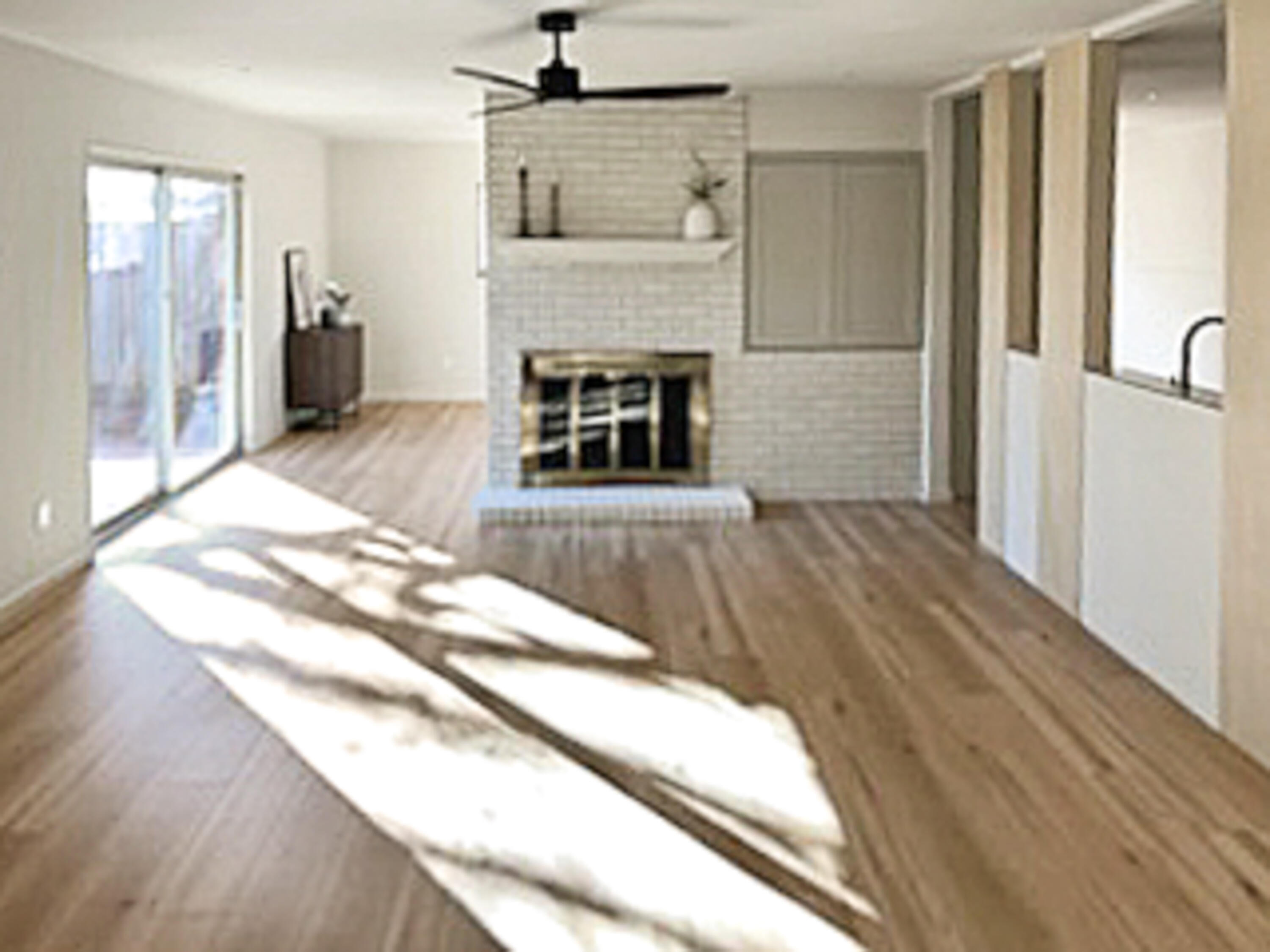 3625 59th Street Lubbock, TX 79413 - Photo 14 of 41 a view of a livingroom with wooden floor and a fireplace