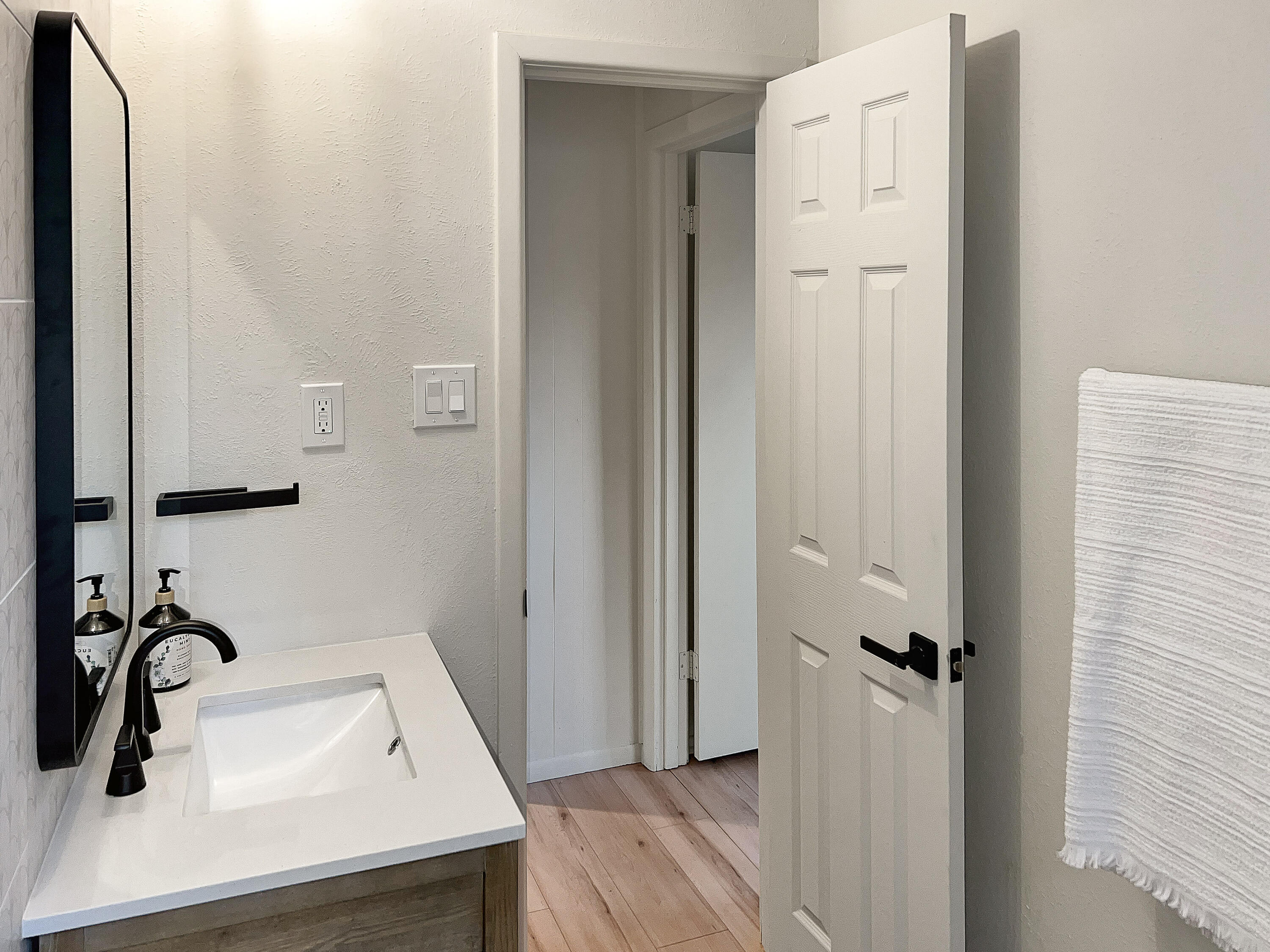 3625 59th Street Lubbock, TX 79413 - Photo 19 of 41 a bathroom with a sink and a mirror