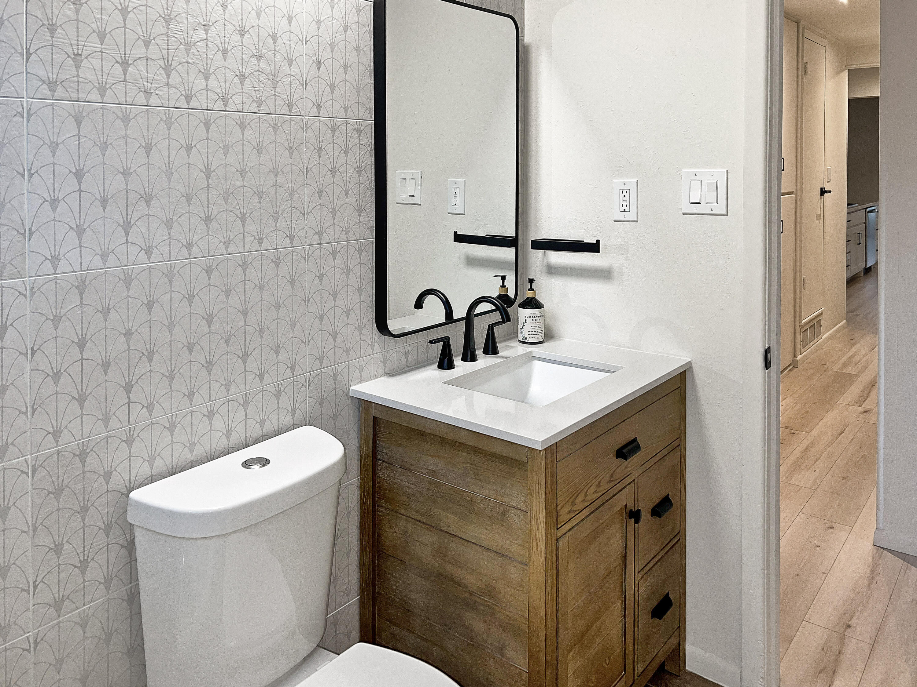 3625 59th Street Lubbock, TX 79413 - Photo 20 of 41 a bathroom with a sink toilet and mirror
