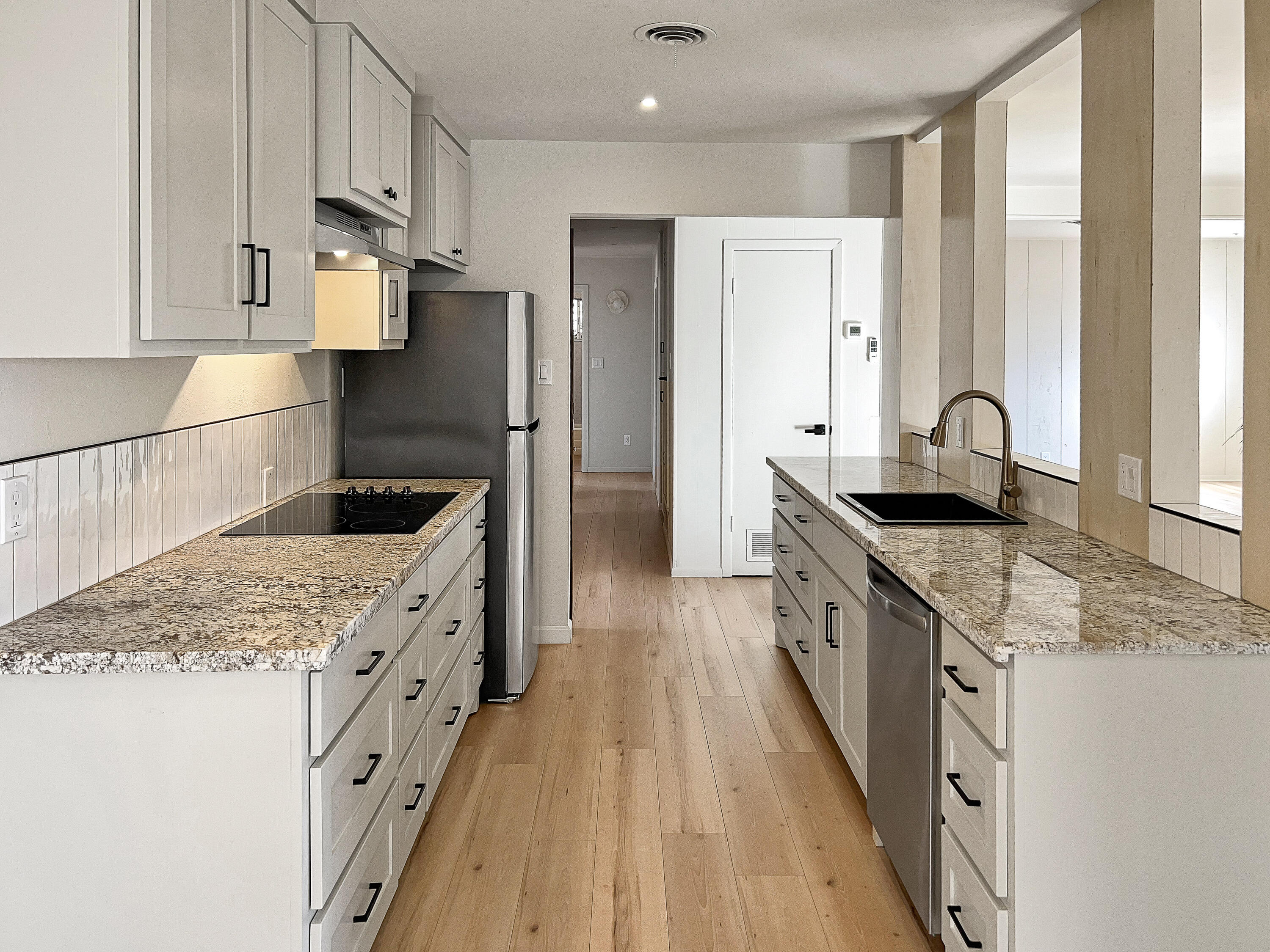 3625 59th Street Lubbock, TX 79413 - Photo 2 of 41 a kitchen with granite countertop a sink stove refrigerator and cabinets