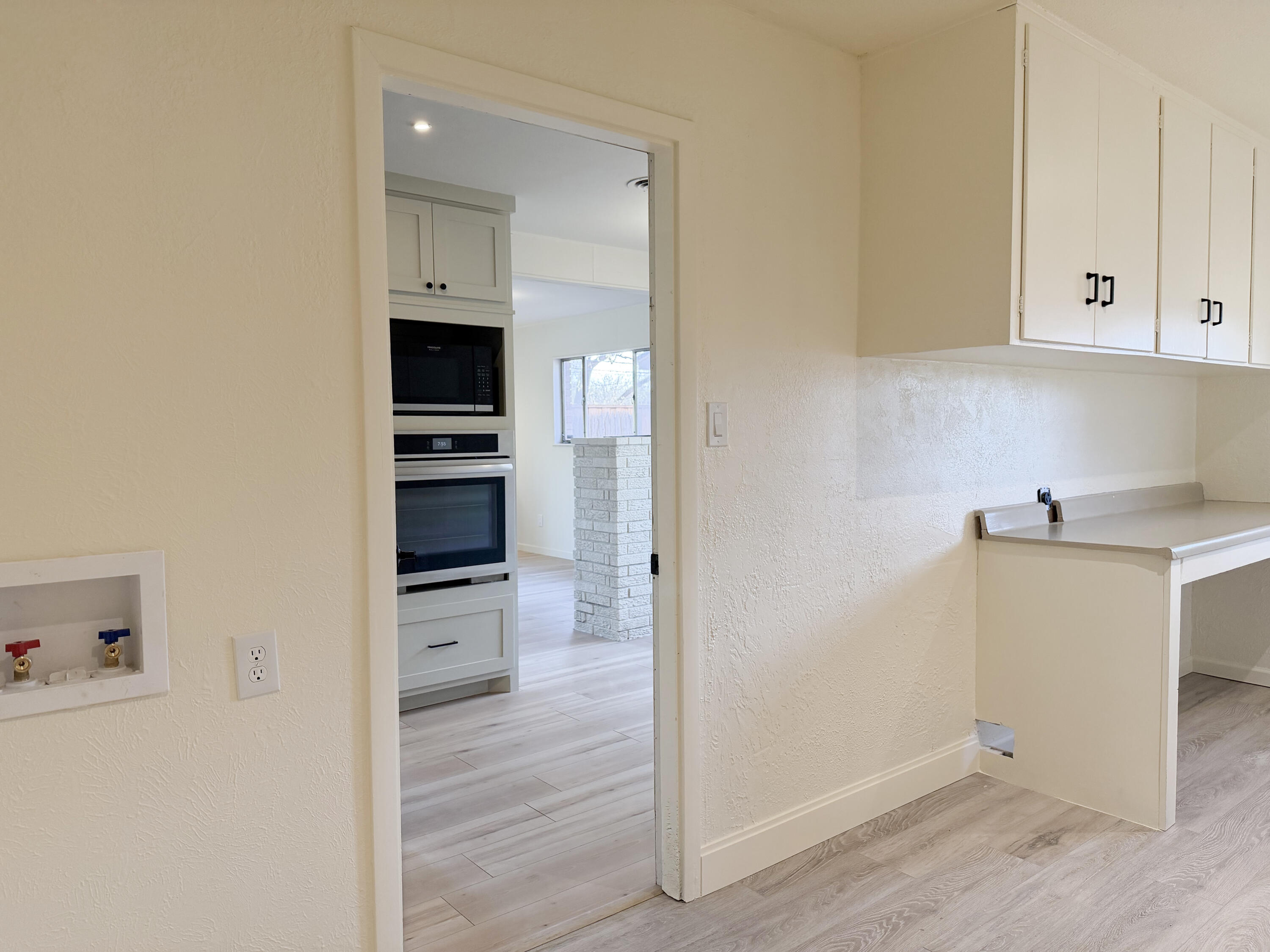 3625 59th Street Lubbock, TX 79413 - Photo 24 of 41 a view of a kitchen with refrigerator and wooden floor