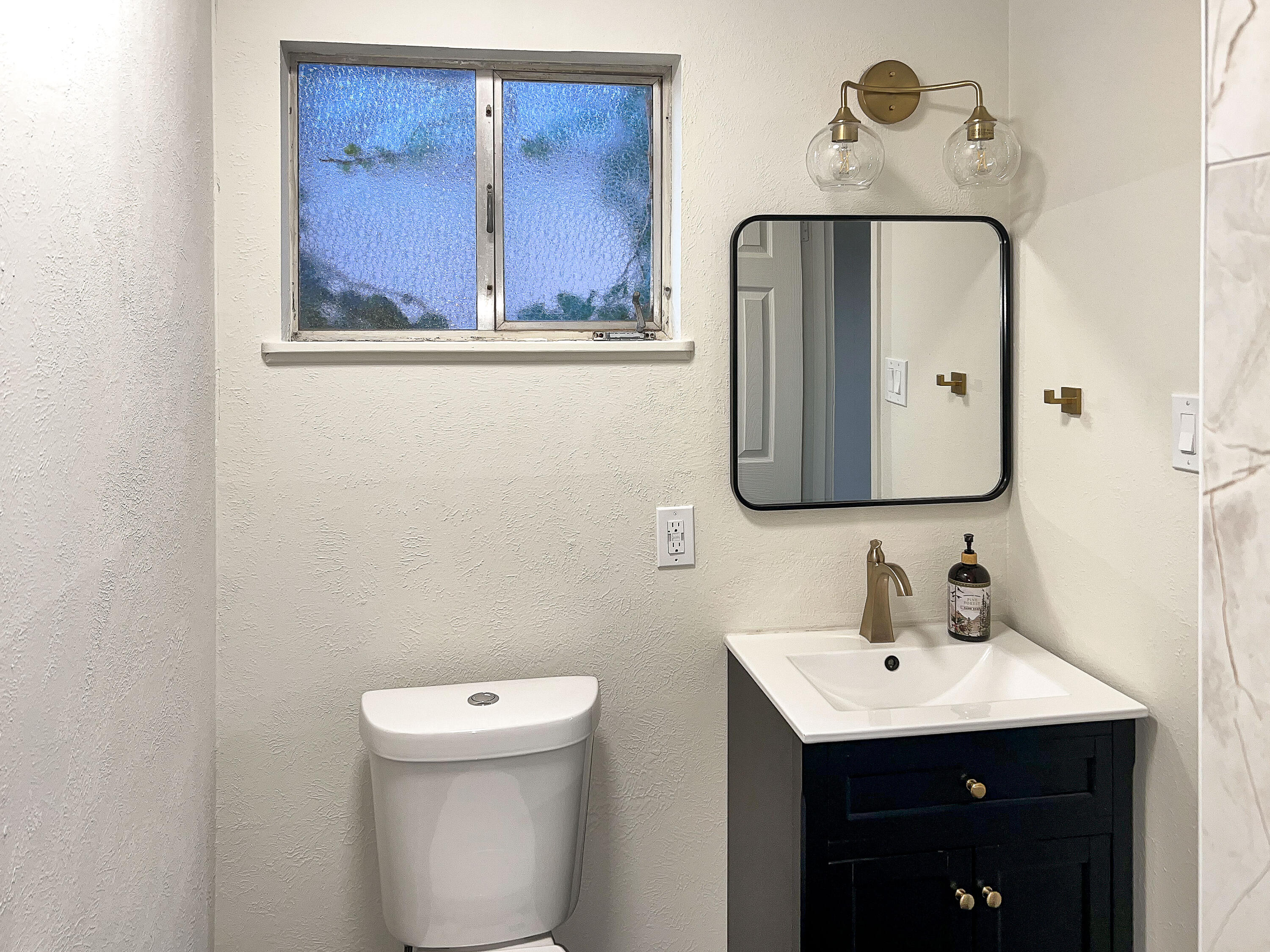 3625 59th Street Lubbock, TX 79413 - Photo 27 of 41 a bathroom with a toilet sink and mirror