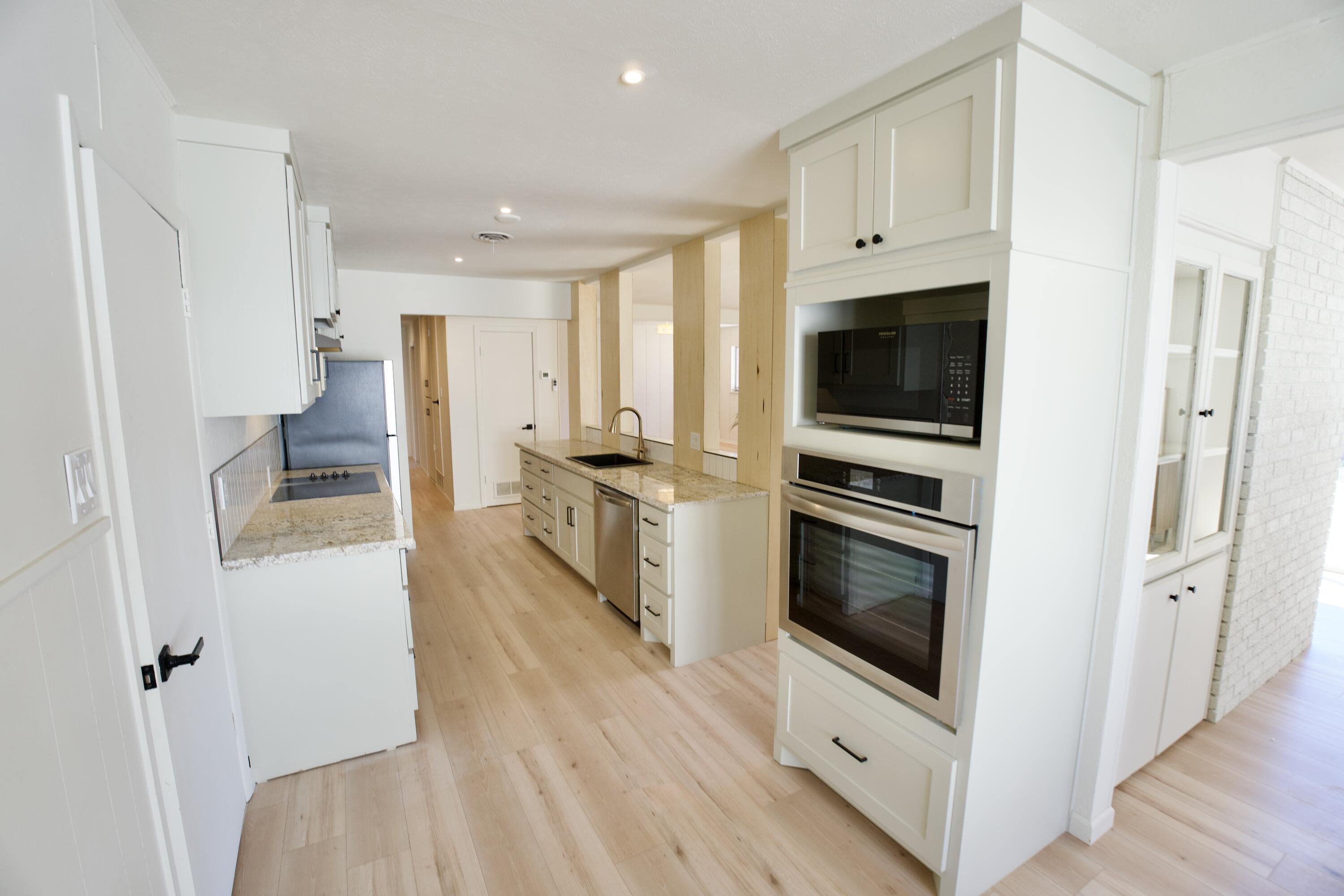 3625 59th Street Lubbock, TX 79413 - Photo 3 of 41 a kitchen with stainless steel appliances a stove a microwave and a refrigerator