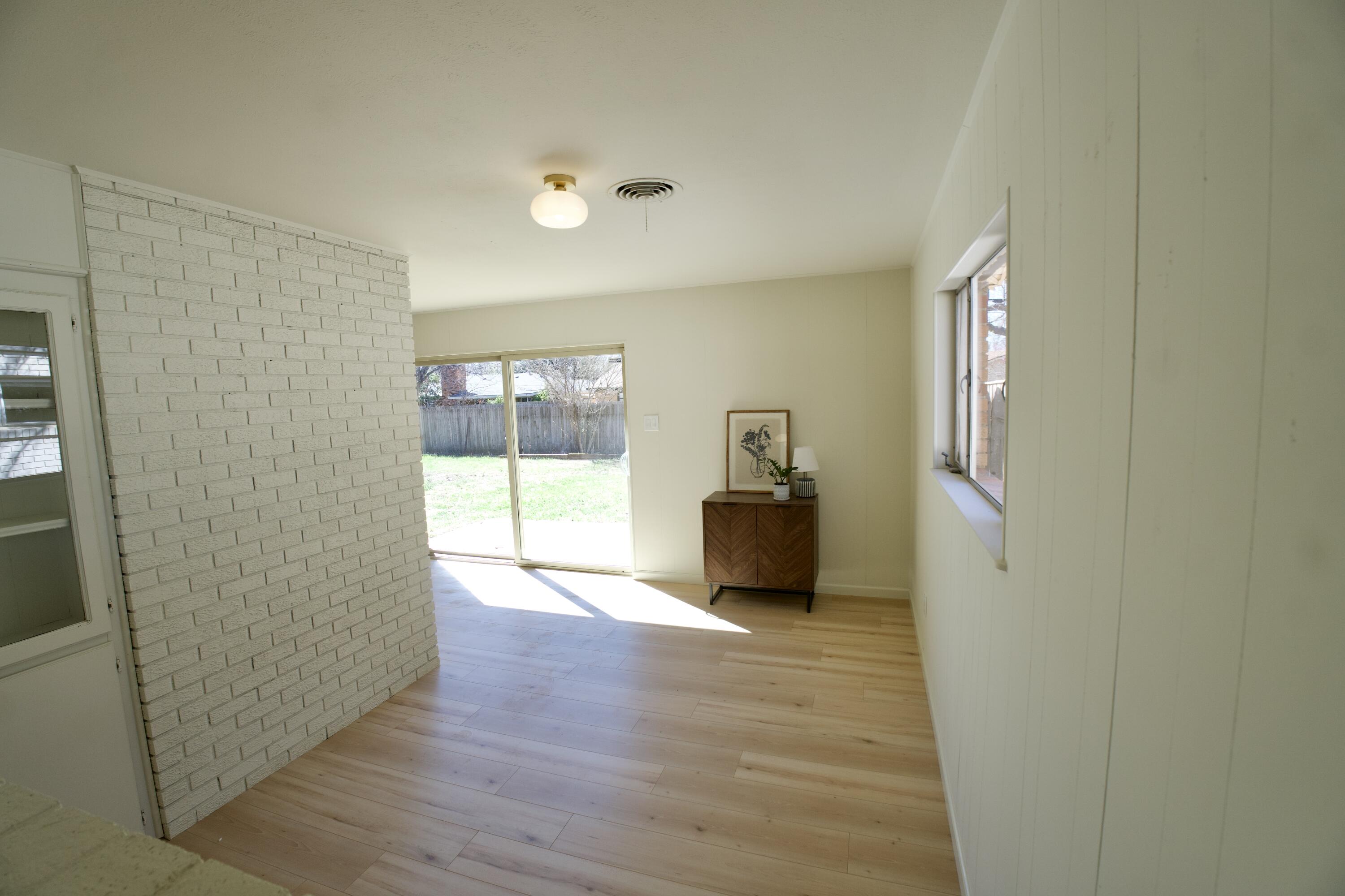 3625 59th Street Lubbock, TX 79413 - Photo 31 of 41 a view of an empty room with wooden floor and a window