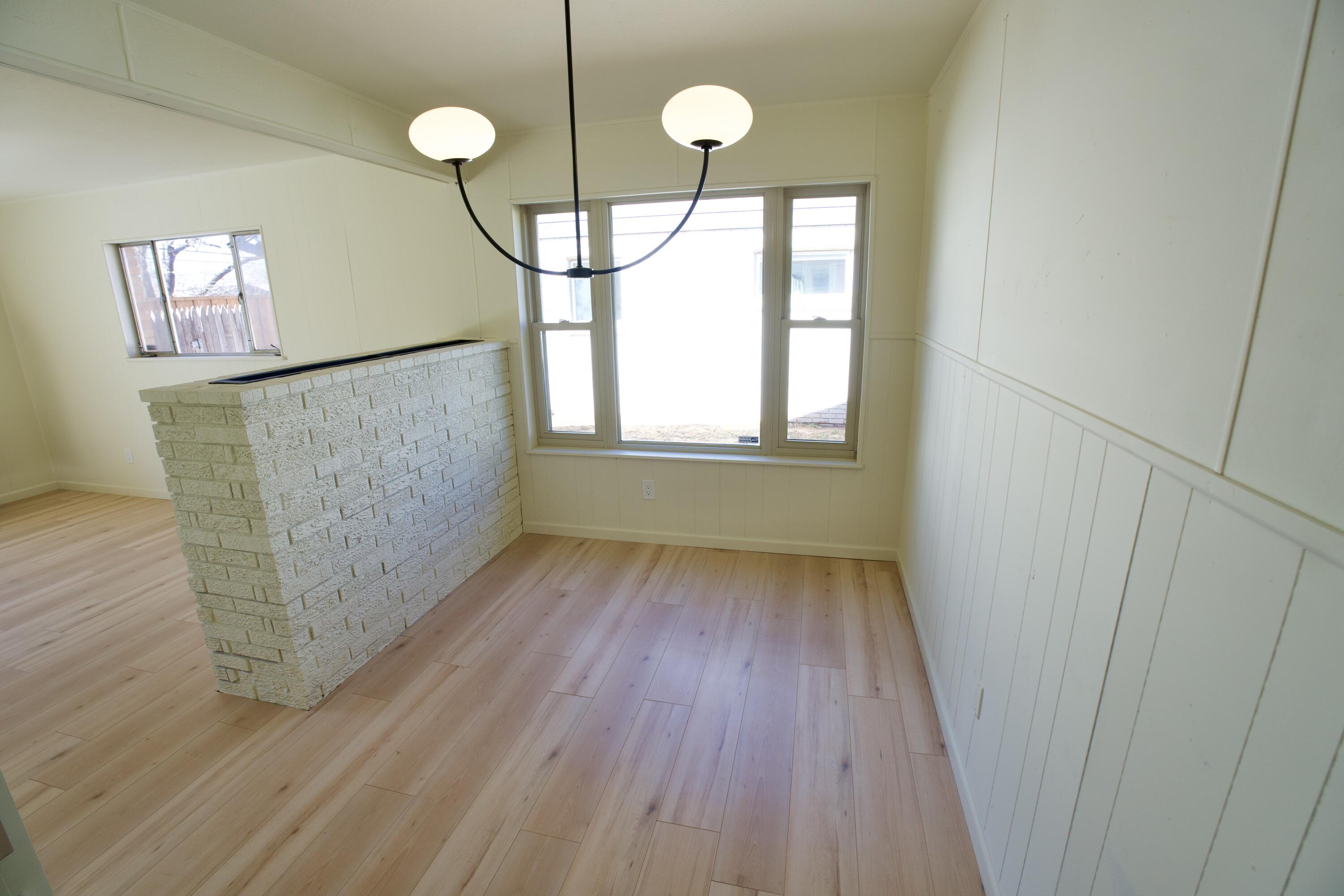 3625 59th Street Lubbock, TX 79413 - Photo 32 of 41 a view of an empty room with wooden floor and a window