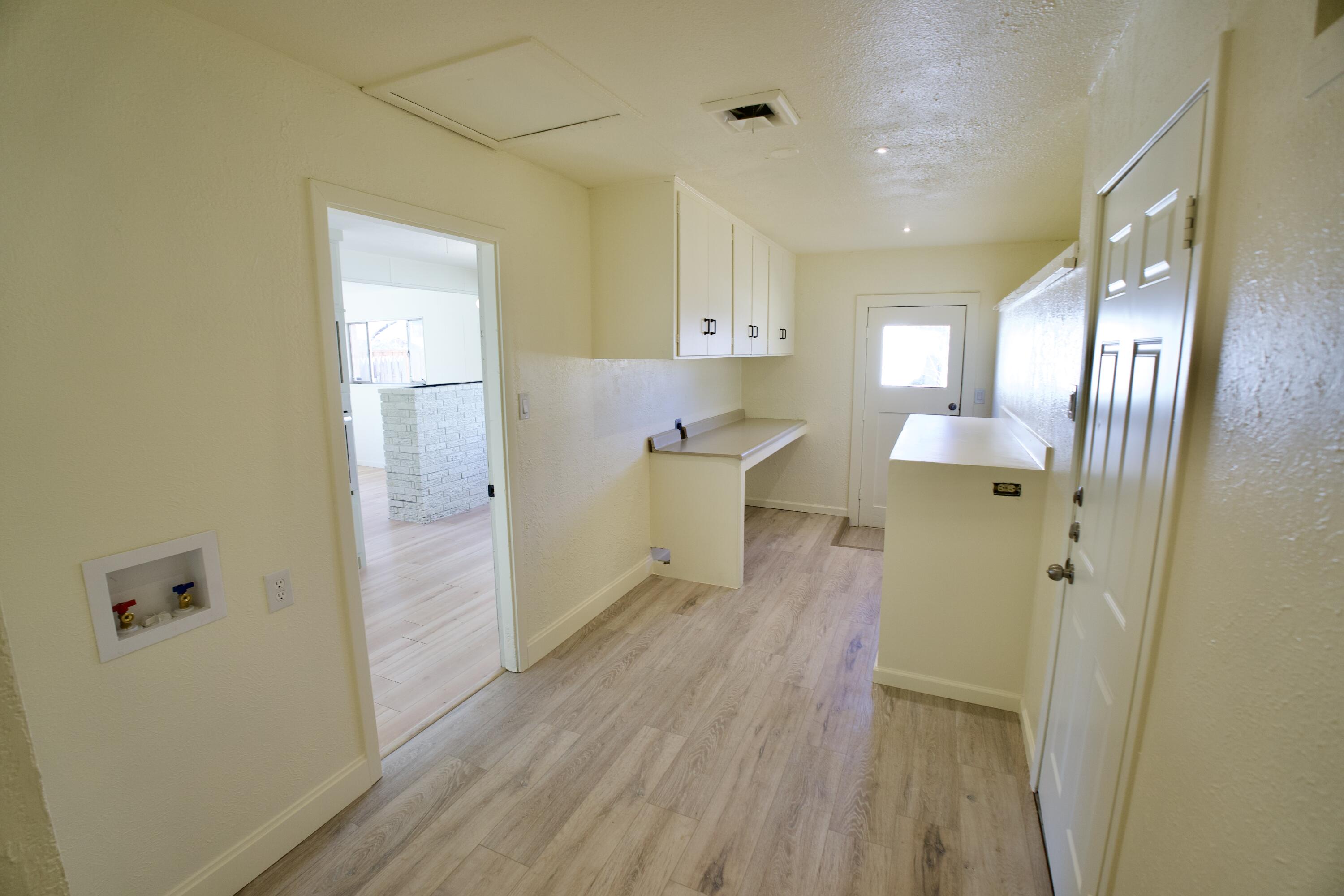 3625 59th Street Lubbock, TX 79413 - Photo 35 of 41 a view of a hallway with wooden floor and a cabinet