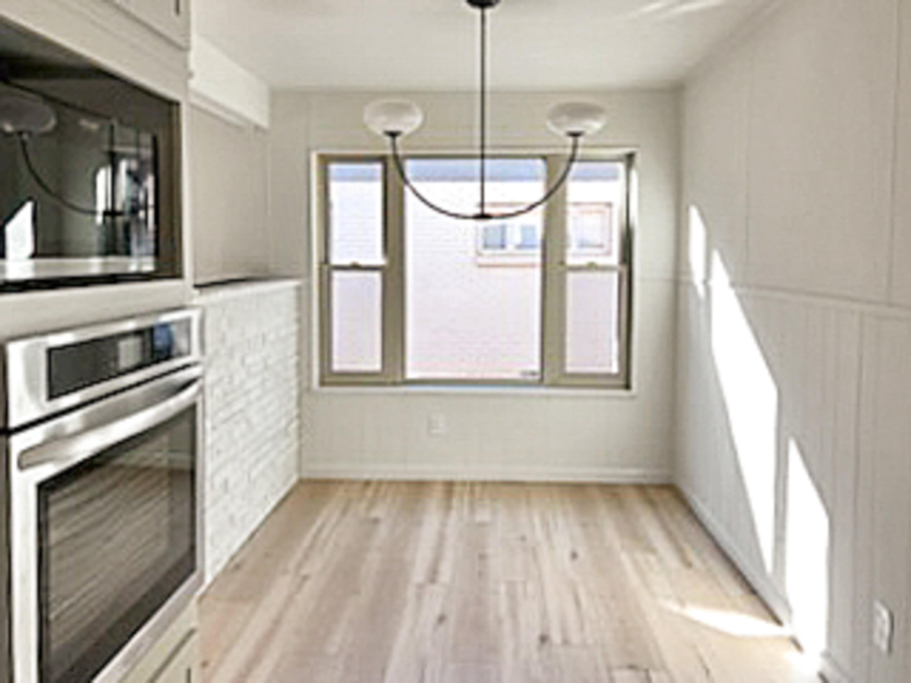 3625 59th Street Lubbock, TX 79413 - Photo 4 of 41 a view of an empty room with a window and wooden floor